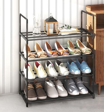 Black 4-tier metal tube shoe rack 55cm in hallway with colorful flats and loafers, lantern and decor on top