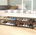 Two 2-tier black metal shoe racks side by side under bunk bed loaded with loafers and casual shoes