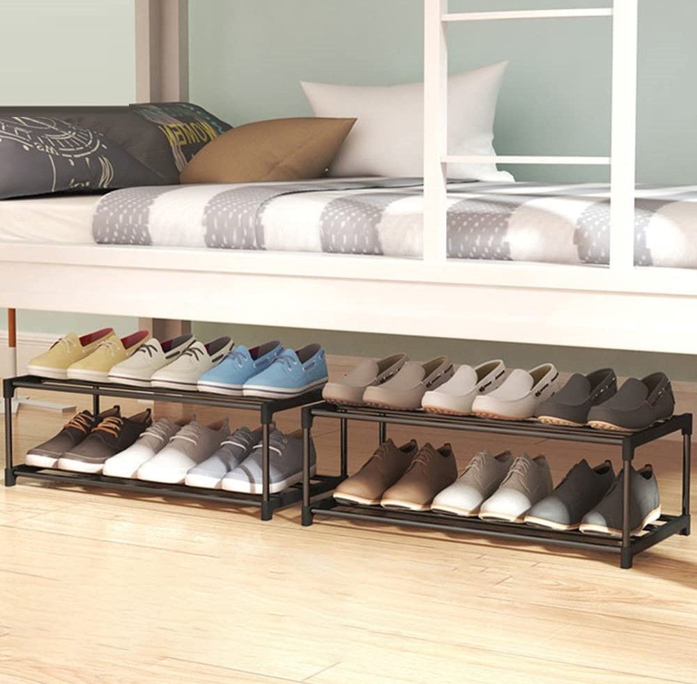Two 2-tier black metal shoe racks side by side under bunk bed loaded with loafers and casual shoes