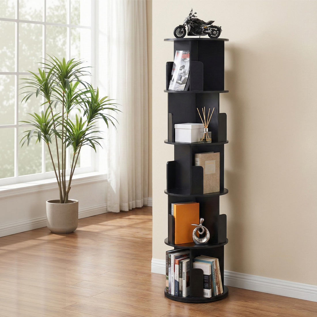 Black 5-tier spiral rotating bookshelf with round shelves in living room, holding books, decor and ornaments