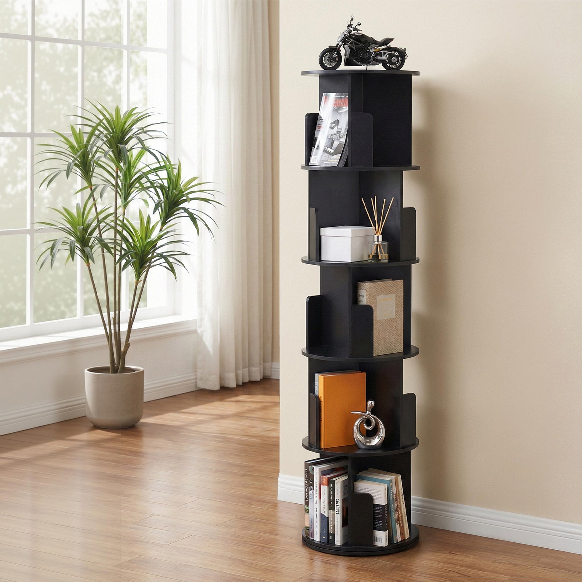 Black 5-tier spiral rotating bookshelf with round shelves in living room, holding books, decor and ornaments