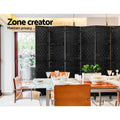 Black 6-panel woven paper rope room divider in dining room lifestyle with leather chairs and glass wood dining table