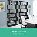 Two black S-shaped bookcases in dining room beside white dining table, text reads Doubly Useful