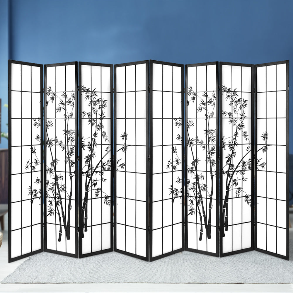 Black 8-panel bamboo print shoji room divider against blue wall showing bamboo ink print design across all eight panels