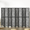 Black 8-panel MDF room divider with geometric star pattern cutouts in lifestyle room with chair and ottomans