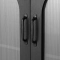 Close-up of two black bar pull handles on the upper arched glass cabinet doors, fluted glass panels on either side