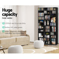 Black media storage shelf in living room, text: holds 1116 CDs or 528 DVDs, BluRay, VHS, video games