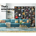 Multiple black media storage shelves as wall display behind teal sofa, text reads That's entertainment