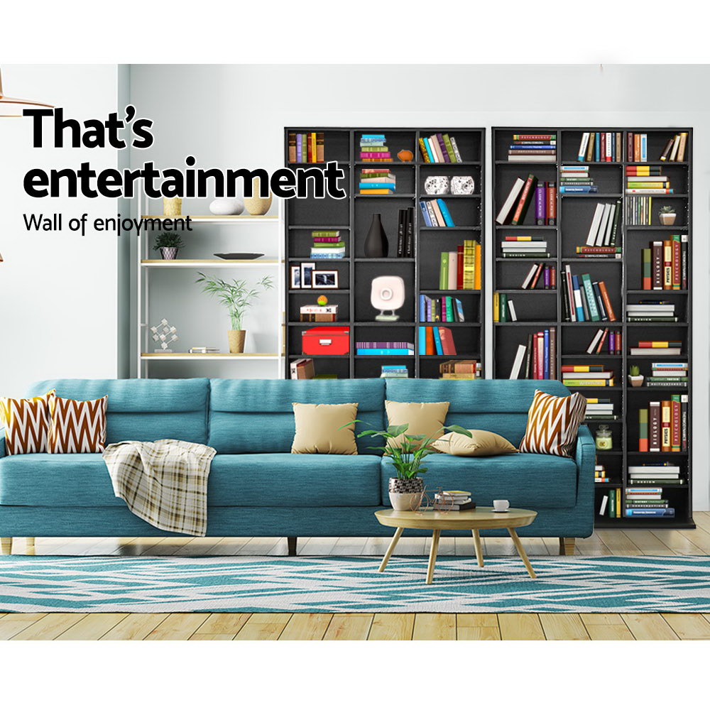 Multiple black media storage shelves as wall display behind teal sofa, text reads That's entertainment