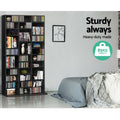 Tall black CD and DVD media unit in bedroom filled with CDs, text: Sturdy always, Heavy-duty made, 85kg capacity