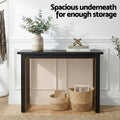 Black console table in hallway with open lower space and wicker baskets, text 