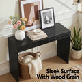 Black console table styled in entryway with text 