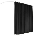Black room divider curtain hanging from white curved ceiling track product shot showing arc of track on white background