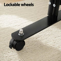 Black room divider lockable wheels close-up on cream rug with black caster wheel and lock toggle