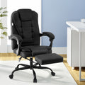 Black fabric high-back office chair with footrest extended in lifestyle home office setting