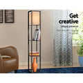 Black shelf floor lamp in lounge setting with books and orange vase on shelves, text overlay Get creative