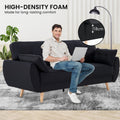 High-density foam infographic showing man seated on black fabric sofa bed in room with 18cm foam depth callout
