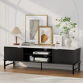 Black fluted sliding door TV unit marble top lifestyle in arched white room with art prints lamp plant and books