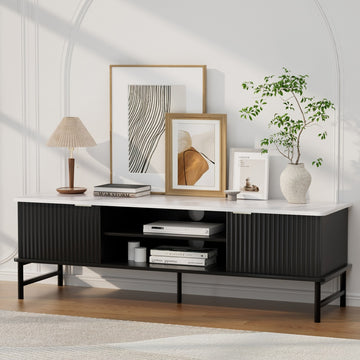 Black fluted sliding door TV unit marble top lifestyle in arched white room with art prints lamp plant and books