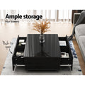Black gloss coffee table with four push-to-open drawers all open showing storage in living room