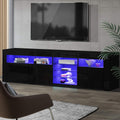 Black glossy LED TV unit 180cm in living room with blue LED illuminating shelves holding books and headphones