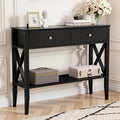 Black hall table with two drawers, chrome knobs, X-cross side panels, lower shelf, styled with decor in classic room setting