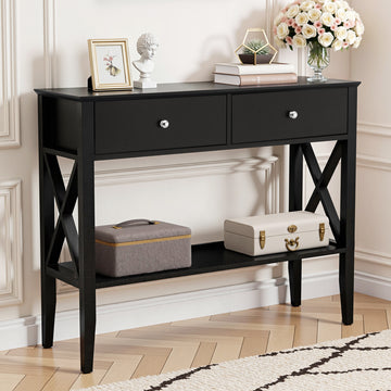Black hall table with two drawers, chrome knobs, X-cross side panels, lower shelf, styled with decor in classic room setting