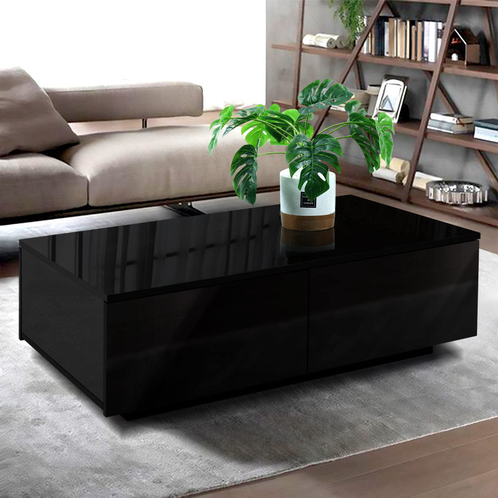 Side view of black L-shaped coffee table with open lower storage shelf