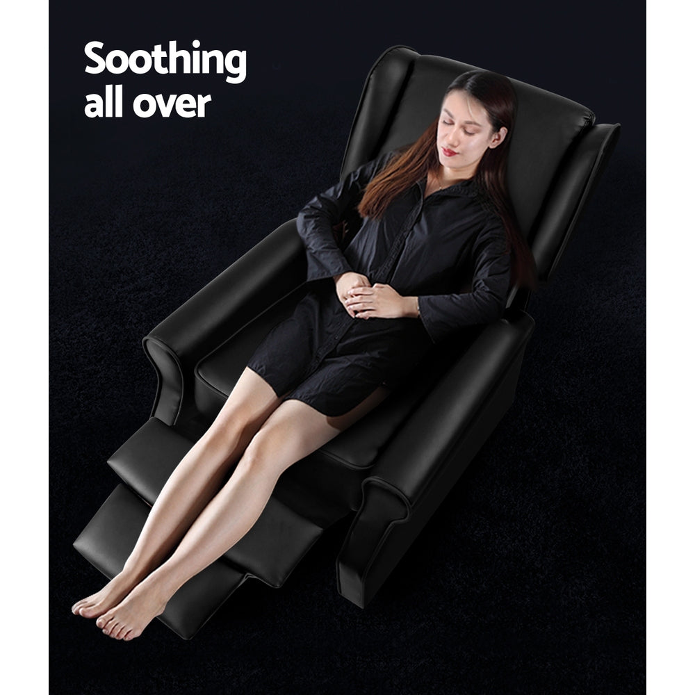 Black faux leather wingback recliner with woman fully reclined and footrest extended, Soothing all over text