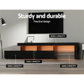 Black LED TV unit in living room with orange LED lighting showing 90kg top and 10kg drawer capacity labels