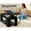 Black lift-top coffee table angled view showing legs, surface, and lower shelf