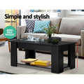 Close-up of black lift-top coffee table hinge mechanism with top panel partially raised
