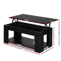 Black lift-top coffee table with top panel raised revealing interior storage compartment