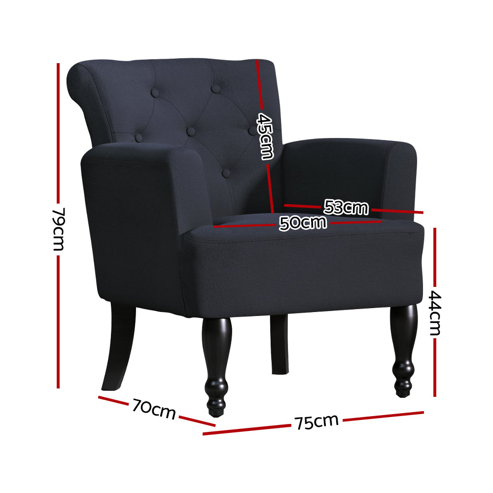 Dark charcoal linen armchair with button-tufted back, rolled top, curved armrests, and turned black wooden legs, angle view