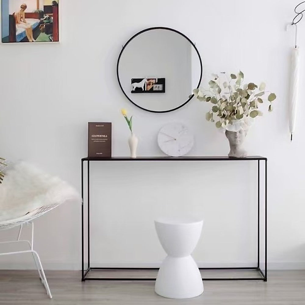 Slim black metal console table with thin tubular steel frame and black top, open rectangular base, white background