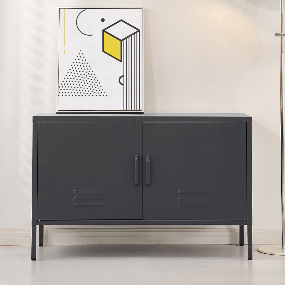 Charcoal black two-door metal sideboard cabinet with louvre vents on grey floor, abstract art print on top