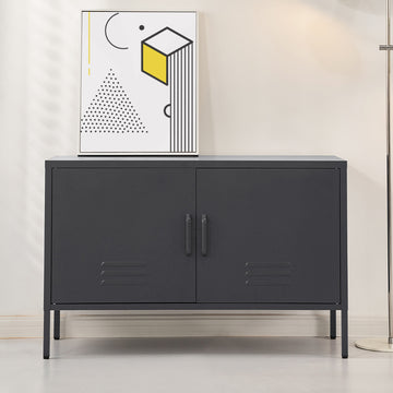 Charcoal black two-door metal sideboard cabinet with louvre vents on grey floor, abstract art print on top