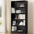Black open bookcase with six shelves and central divider, styled with books and decor in a bright living room