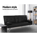 Black PU leather sofa bed in living room with tripod floor lamp, metal shelf and marble coffee table