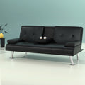 Black PU leather sofa bed with centre cup holder tray open holding two coffee cups against teal wall