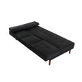 Black PU leather sofa bed fully reclined flat showing walnut legs on white background