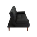 Side view of black PU leather sofa bed with tufted back and small bolster armrest on white background