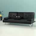 Black PU leather sofa bed with open cupholder and two cups against teal wall, yellow vase on black side table