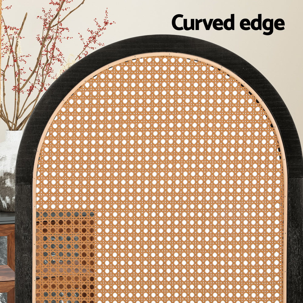 Black arched rattan room divider curved edge close-up in lifestyle with red berry branch vase and sideboard