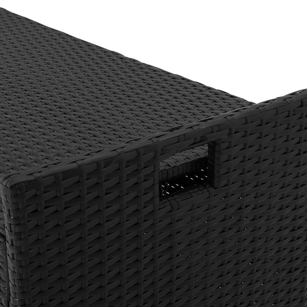 Close-up of black rattan weave texture with integrated handle cutout on side of storage bench
