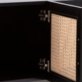 Black rattan TV unit door open showing interior black cabinet metal hinge hardware and cane-weave door back