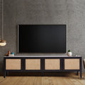 Black rattan TV unit in grey concrete room with wall-mounted TV pendant light copper mug and small plant