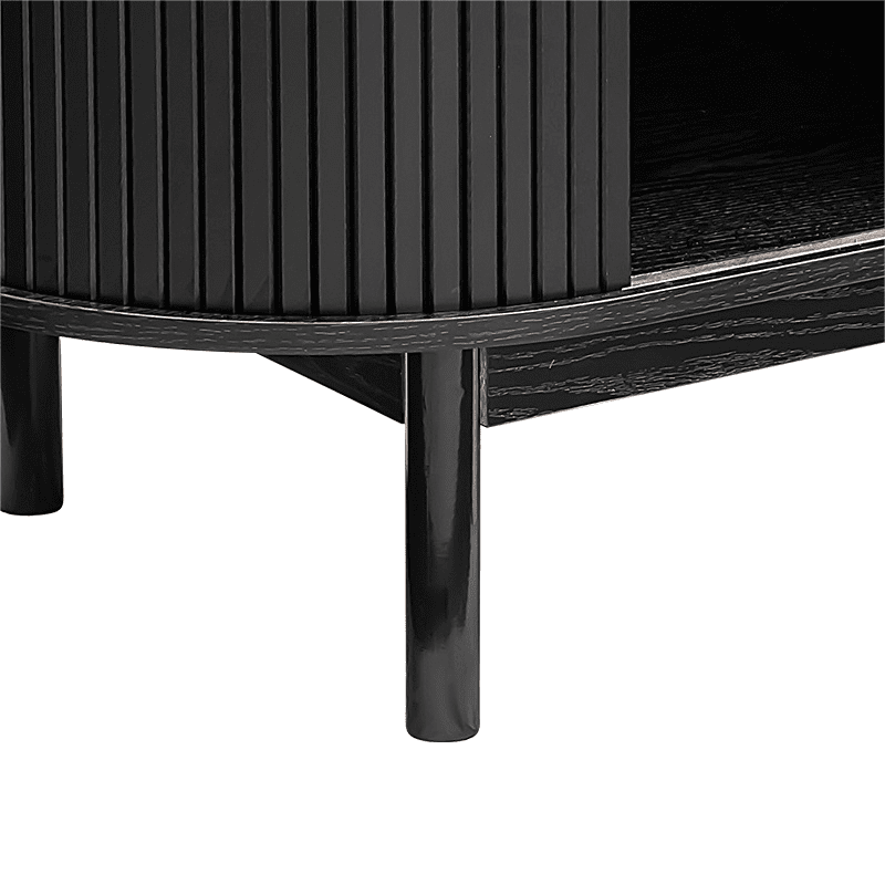 Close-up of black reeded sideboard curved base rail, rounded end reeded panel and two tapered legs