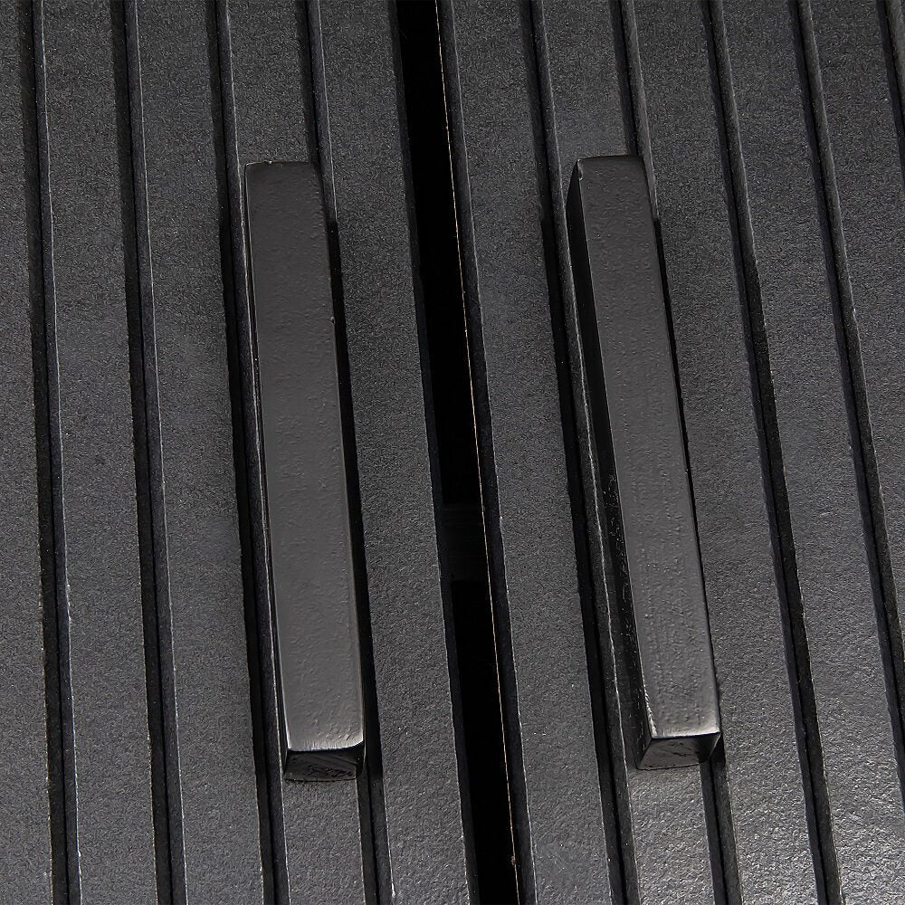 Close-up of black reeded sideboard showing two matte black square bar handles on reeded door panels