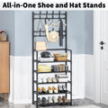 Tall black steel shoe and hat stand in entryway loaded with shoes bags hat and clothes with all-in-one text